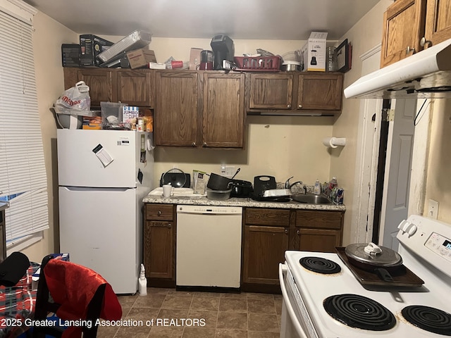 kitchen with white appliances, sink, and dark brown cabinets