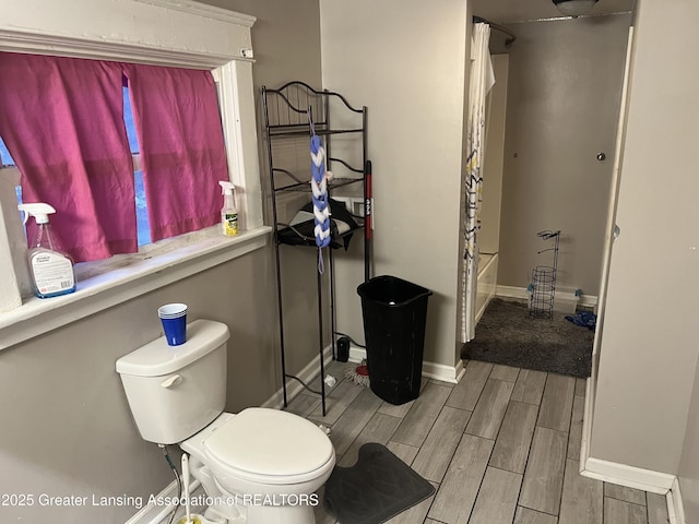 bathroom with toilet and shower / bathtub combination with curtain