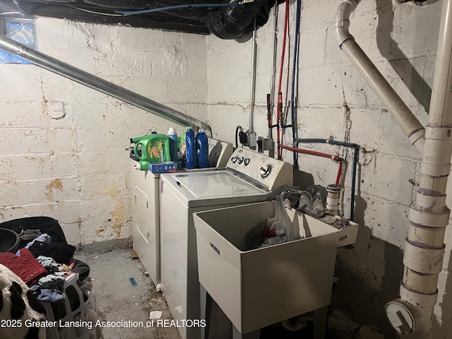 laundry room with washing machine and clothes dryer and sink