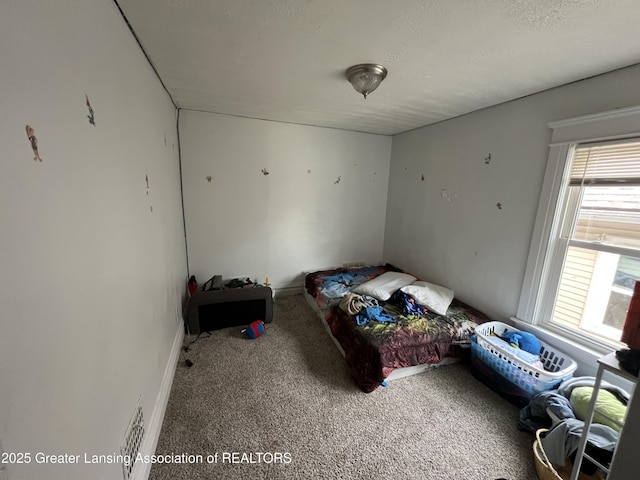 carpeted bedroom with a textured ceiling