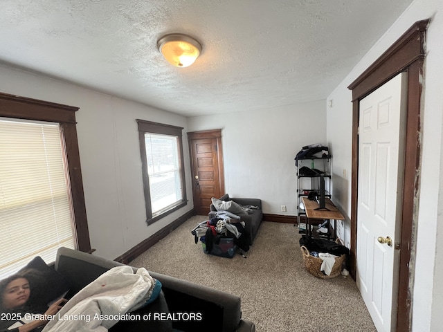 interior space with a textured ceiling and carpet