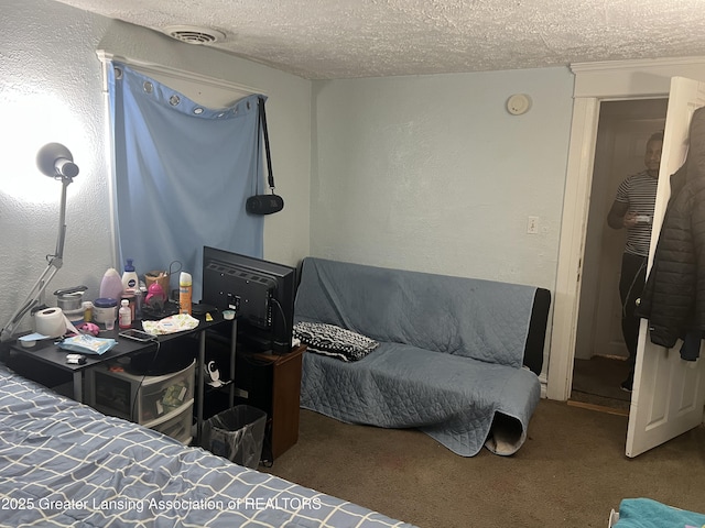 carpeted bedroom with a textured ceiling