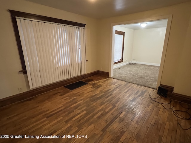 spare room with dark hardwood / wood-style flooring