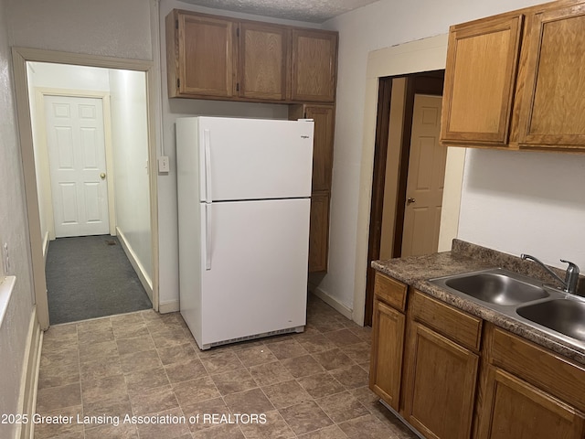 kitchen with white refrigerator and sink