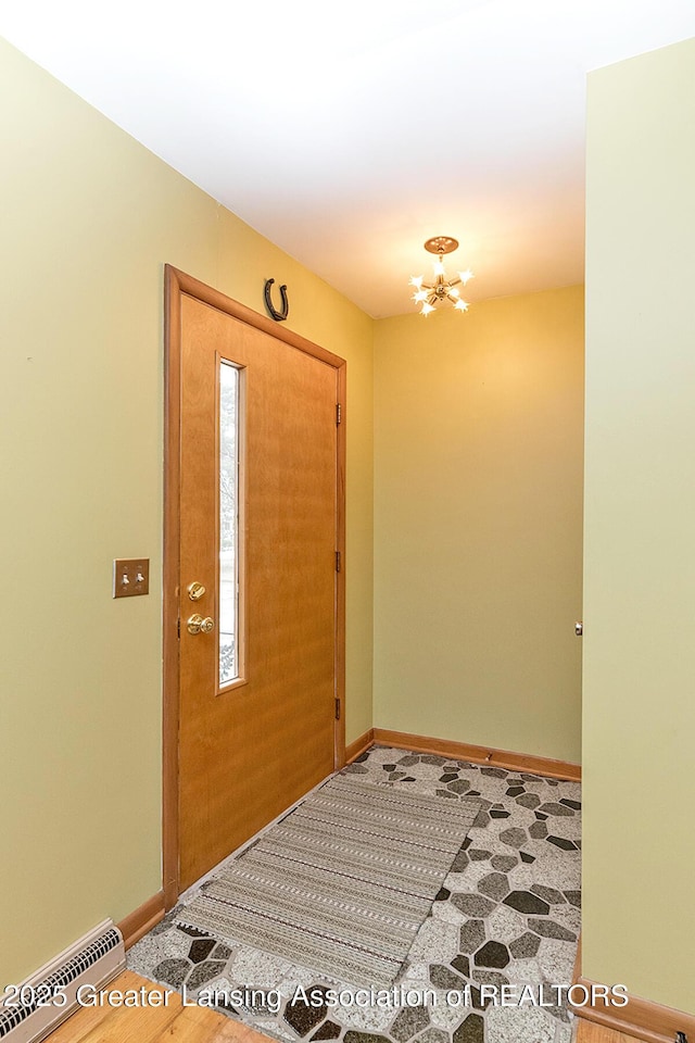 entryway with a chandelier, visible vents, and baseboards