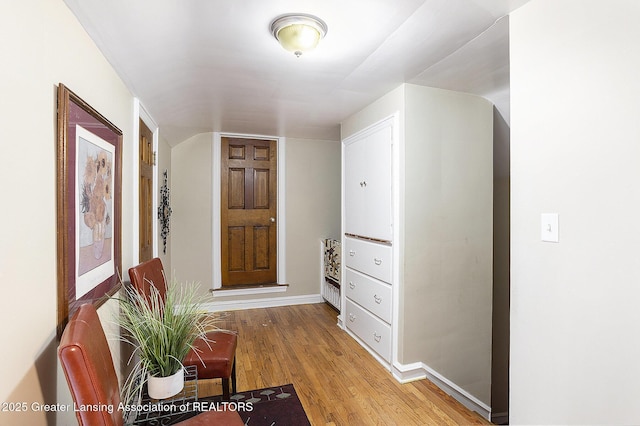 corridor with hardwood / wood-style flooring