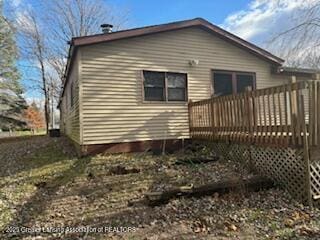 rear view of house featuring a wooden deck