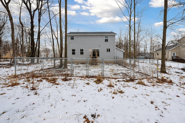 view of snow covered rear of property