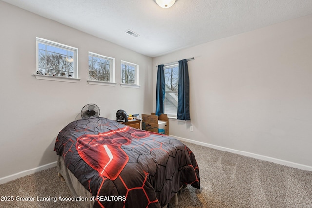 bedroom with a textured ceiling and carpet