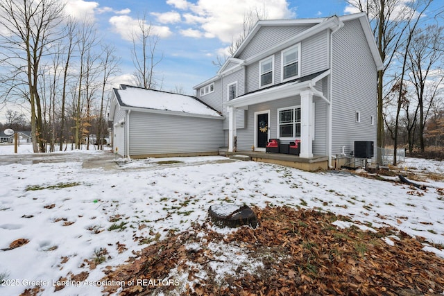 view of property featuring a garage and central AC