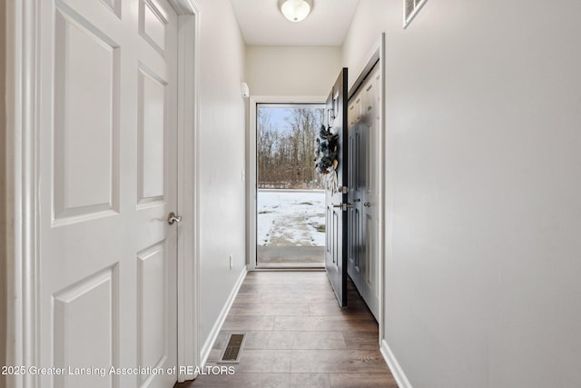 hallway with hardwood / wood-style flooring