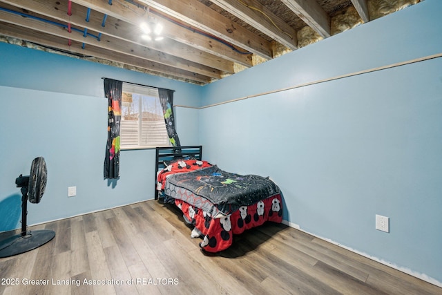 bedroom with hardwood / wood-style flooring