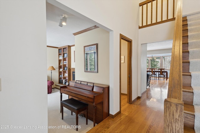 interior space featuring crown molding and light hardwood / wood-style floors