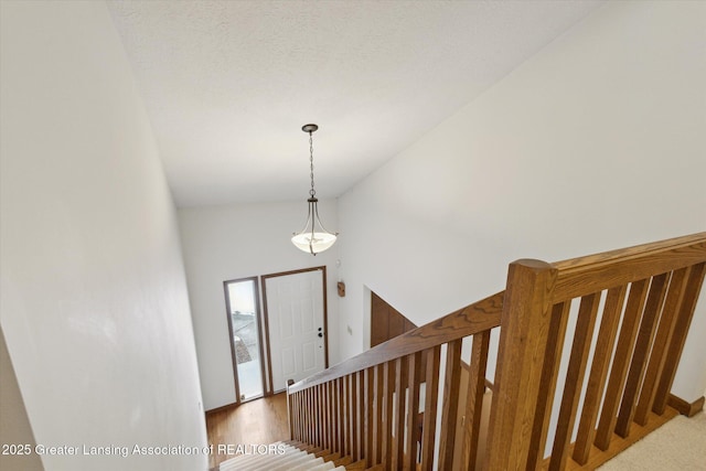 stairs featuring high vaulted ceiling