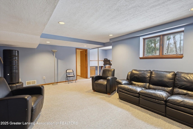 living room featuring carpet floors and a textured ceiling