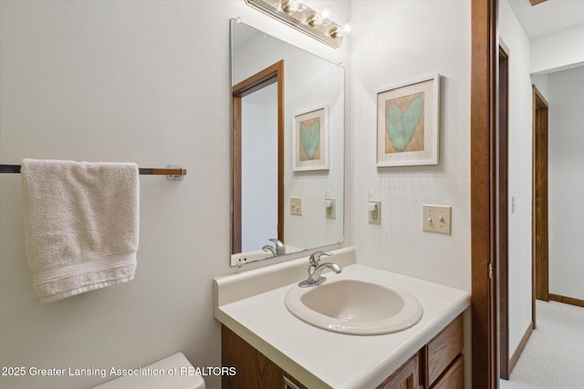 bathroom featuring vanity and toilet