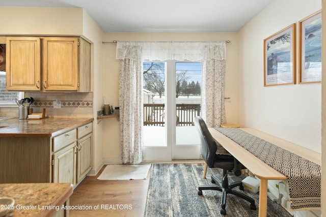 interior space with tasteful backsplash, light brown cabinetry, and light wood-type flooring