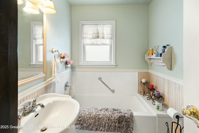 bathroom featuring a bath and sink