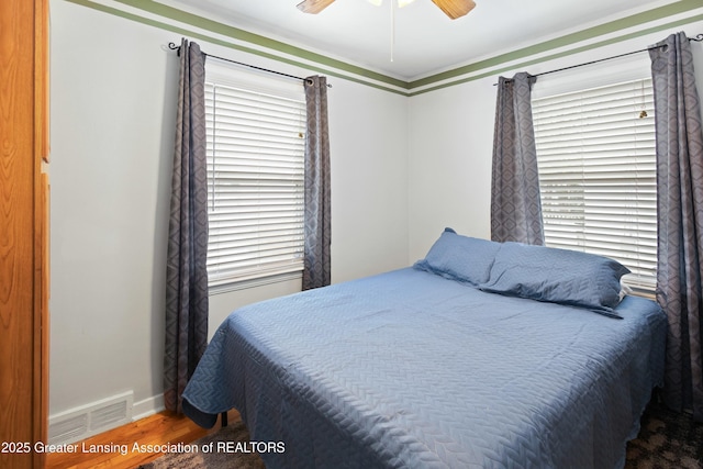 bedroom with hardwood / wood-style floors and ceiling fan