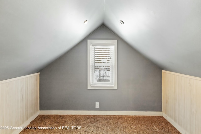 bonus room featuring lofted ceiling and carpet