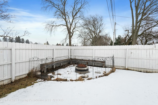 yard covered in snow featuring a fire pit