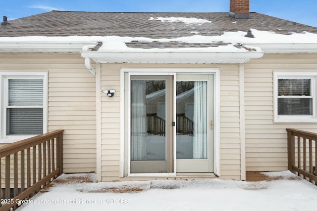 view of snow covered property entrance