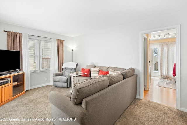 living room with light carpet and rail lighting