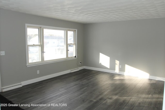 unfurnished room featuring a baseboard heating unit, a textured ceiling, and dark hardwood / wood-style flooring