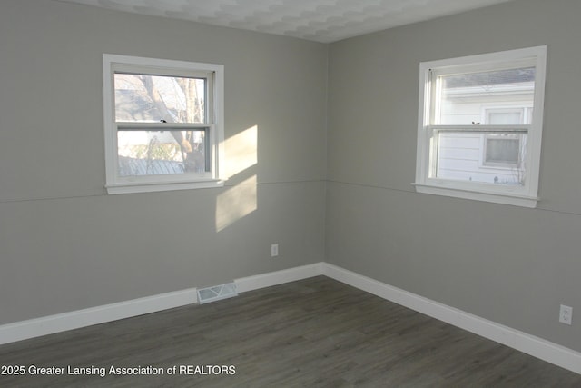 spare room featuring dark hardwood / wood-style flooring