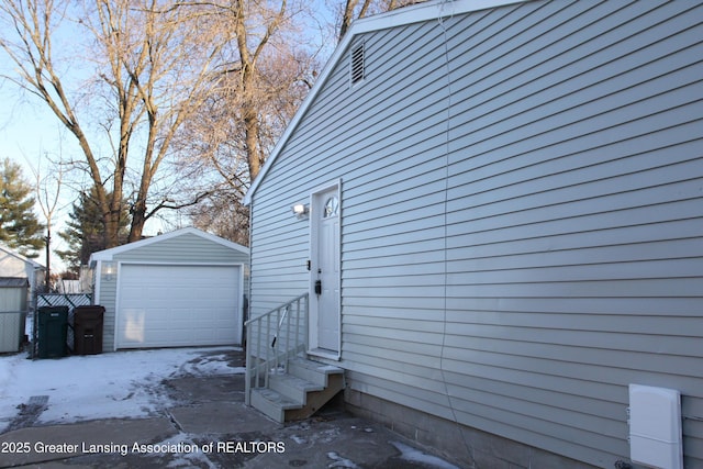 view of side of property with a garage and an outbuilding