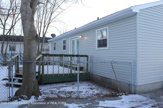 view of snow covered rear of property