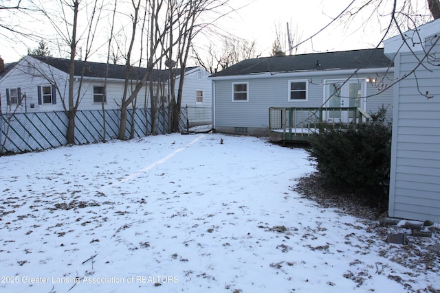 view of snow covered rear of property