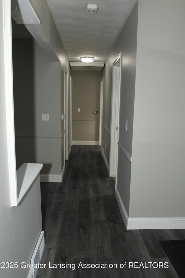 corridor with dark hardwood / wood-style floors