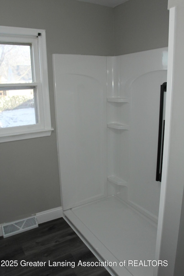 bathroom with walk in shower and hardwood / wood-style flooring