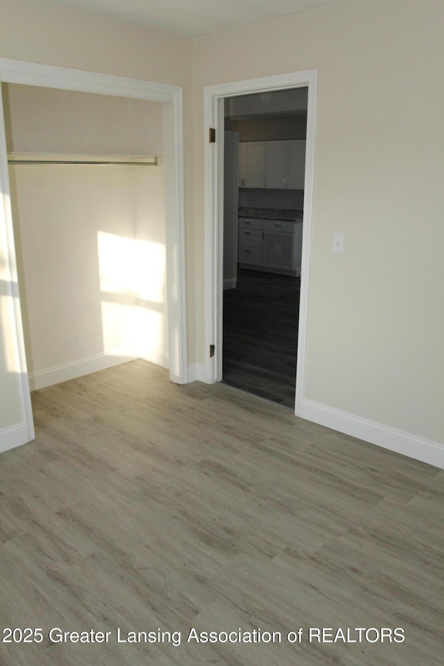 unfurnished room with wood-type flooring