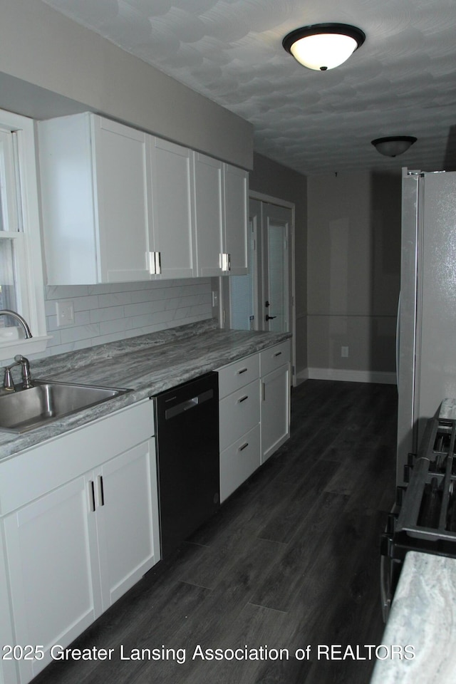 kitchen featuring dishwasher, sink, white cabinets, decorative backsplash, and dark wood-type flooring