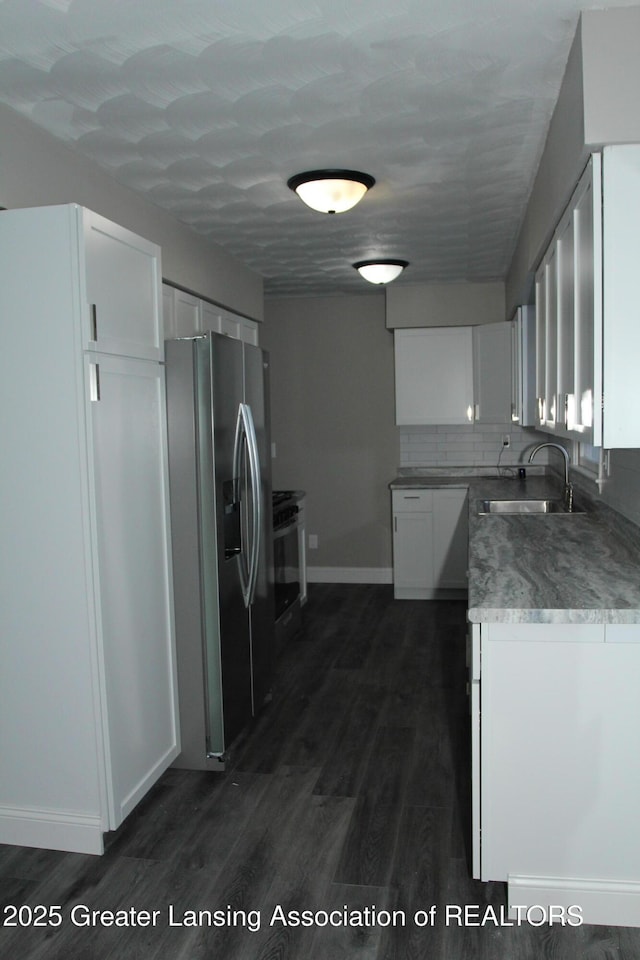 kitchen with white cabinetry, sink, stainless steel fridge, and dark hardwood / wood-style flooring