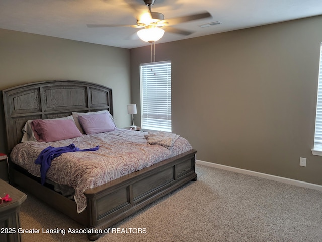 bedroom featuring light colored carpet and ceiling fan