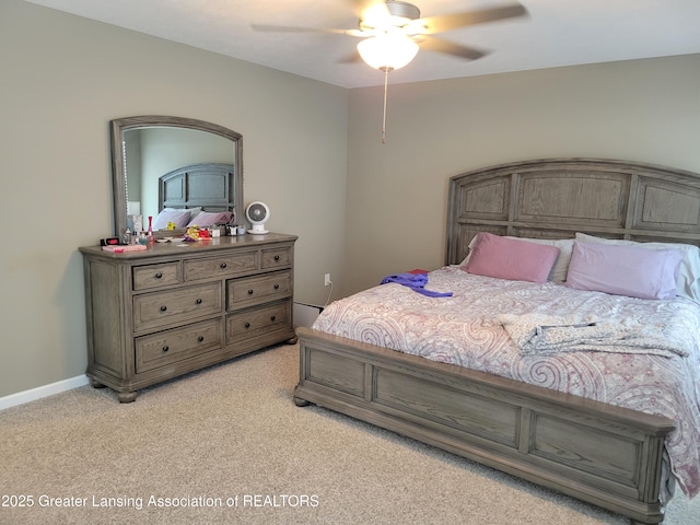 bedroom featuring light carpet and ceiling fan