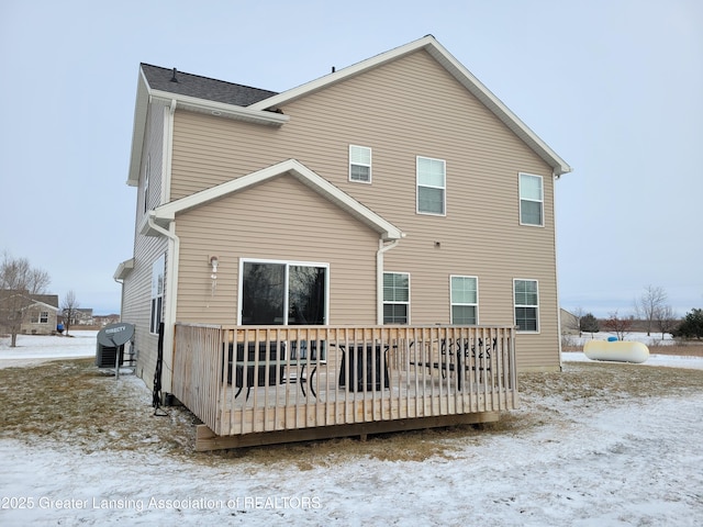 snow covered house with a deck