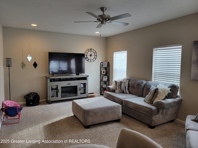 carpeted living room featuring ceiling fan