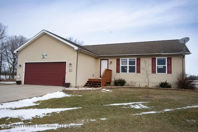 single story home featuring a garage and a yard