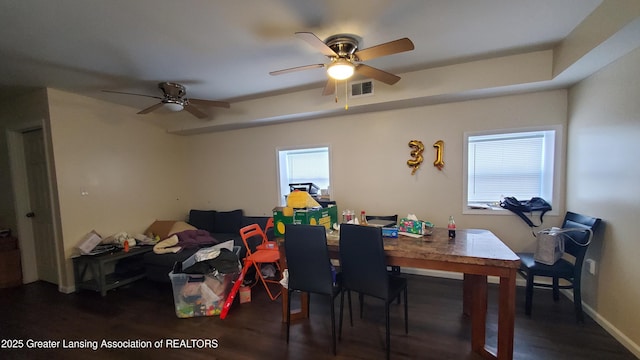 dining area with ceiling fan and dark hardwood / wood-style floors