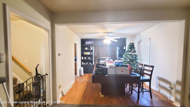 dining space with ceiling fan and hardwood / wood-style floors