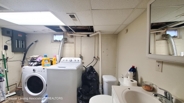 laundry room with sink, electric panel, and washer and clothes dryer