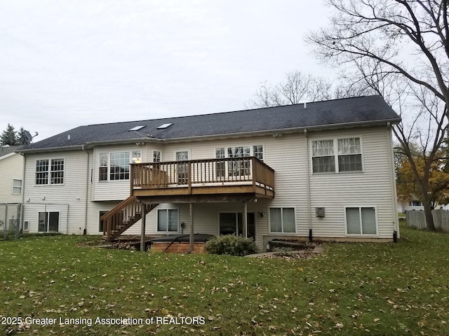 back of house featuring a wooden deck and a lawn