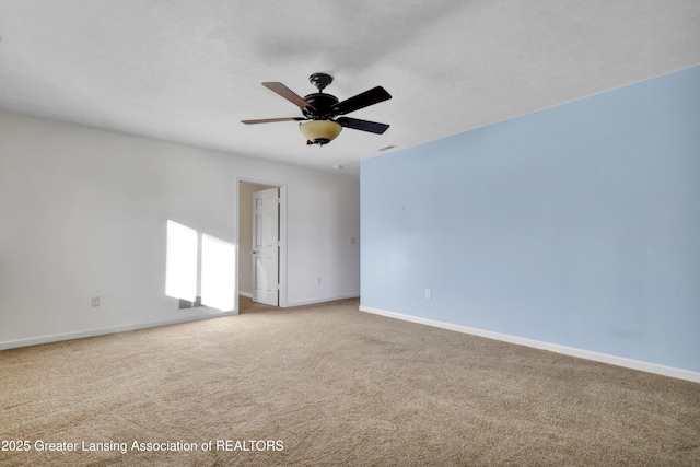 unfurnished room with ceiling fan and carpet