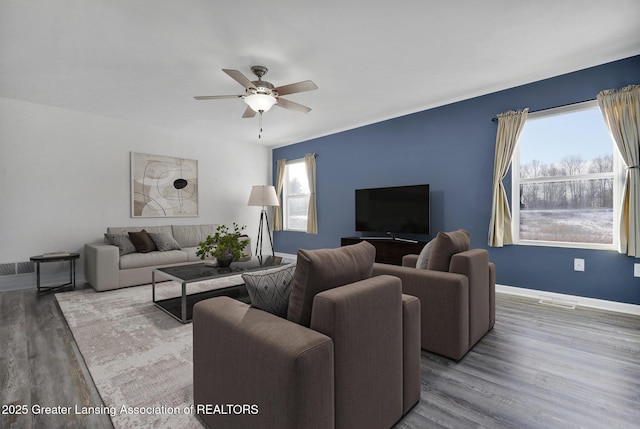 living room featuring hardwood / wood-style floors and ceiling fan