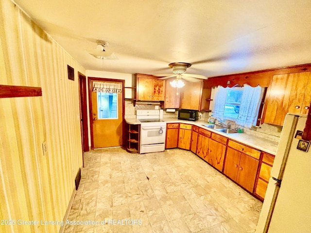 kitchen with ceiling fan, sink, backsplash, and white appliances