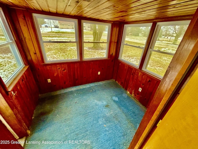 unfurnished sunroom with wood ceiling